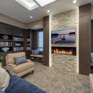 A modern living room with a cozy fireplace and stylish decor.