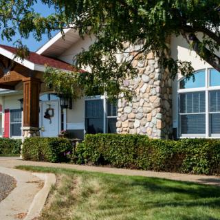 A modern residential house with stone accents and well-maintained landscaping.