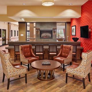 A cozy and modern lobby seating area featuring comfortable chairs and a warm ambiance.
