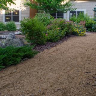 A beautifully landscaped garden pathway leading to a home.