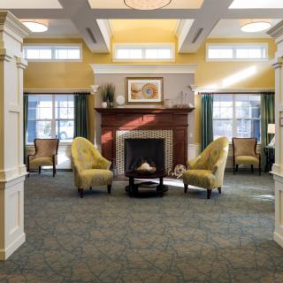 A cozy living room with a central fireplace and comfortable seating.