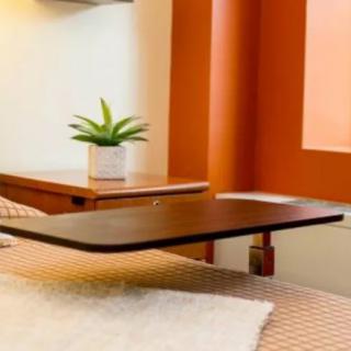 A cozy bedroom corner featuring a small table with a potted plant.