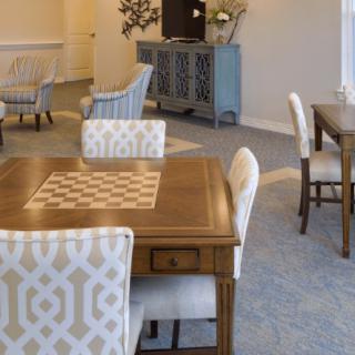 A modern dining area with stylish chairs and a wooden table in a well-decorated living space.