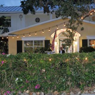 A beautifully lit house in the evening with a welcoming atmosphere.