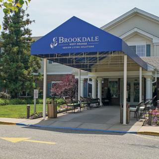 The entrance of a Brookdale retirement home featuring an awning.
