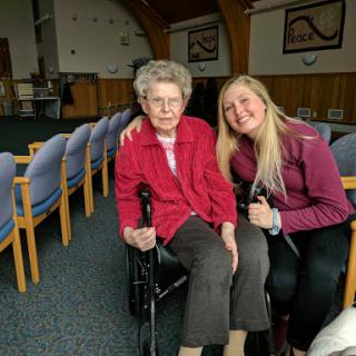 A heartwarming moment shared between a young woman and an elderly lady.