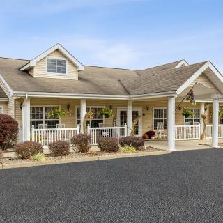 A charming suburban home with a welcoming porch and well-maintained landscaping.