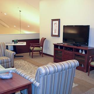 A cozy living room with comfortable seating and a television.