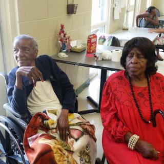 Two elderly women enjoying time together in a community setting.