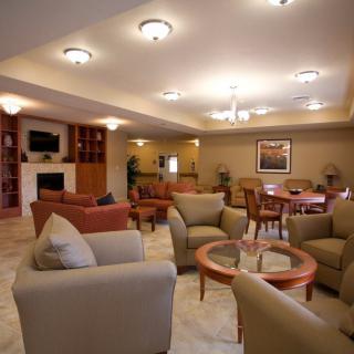 A modern living room with comfortable seating and warm lighting.