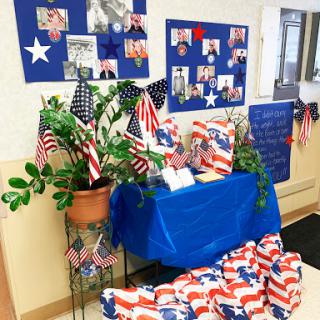 A vibrant display of patriotic decorations featuring flags and photos, ideal for a celebration.