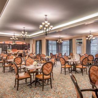 A well-lit dining room with elegant seating and decor.