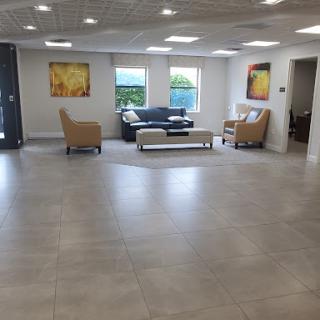 A spacious and modern lobby featuring comfortable seating, contemporary artwork, and ample natural light.