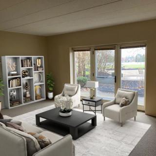 A modern living room with comfortable seating, a central coffee table, and large windows allowing natural light.
