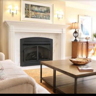 A cozy living room featuring a fireplace, comfortable sofa, and stylish decor.