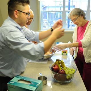 Family members gather in the kitchen to prepare a meal together.