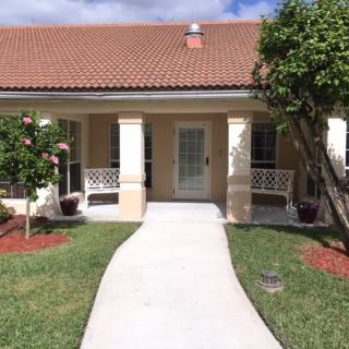 A welcoming house with a front porch and landscaped garden.