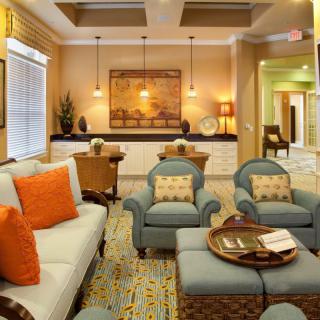 A cozy and elegantly decorated living room with comfortable seating and warm lighting.
