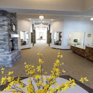 A modern interior hallway featuring bright yellow floral decor and elegant furnishings.