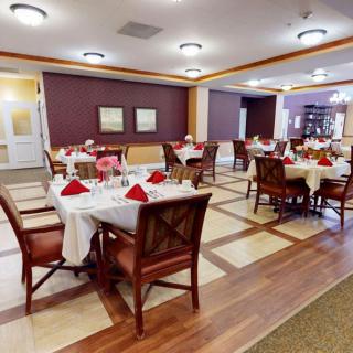 A well-decorated dining room with neatly arranged tables and chairs.
