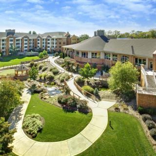 A scenic view of a residential complex with beautifully landscaped gardens and winding pathways.