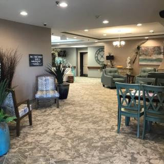 A cozy and elegantly decorated lobby area with comfortable seating and natural accents.