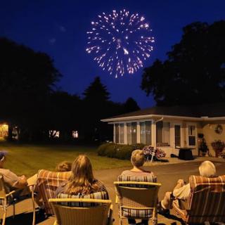 A family enjoying a fireworks display on a warm summer night.