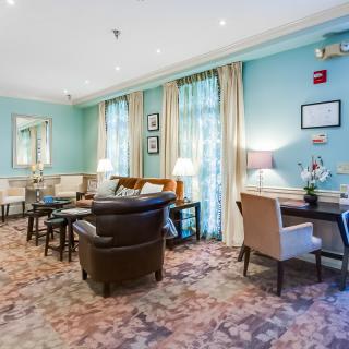 A cozy living room with blue walls, featuring comfortable seating and elegant decor.