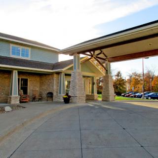 A welcoming entrance to a building with a spacious driveway.