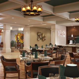 A spacious and elegantly decorated restaurant dining area with tables, chairs, and chandeliers.