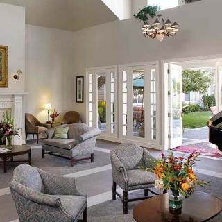 A spacious living room with modern decor, featuring comfortable seating and abundant natural light.