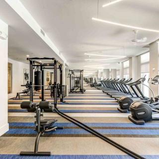 A spacious gym with various fitness equipment including treadmills and exercise machines.