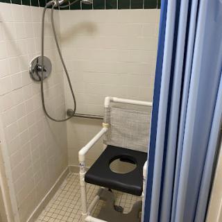 An accessible shower equipped with a shower chair for ease of use.