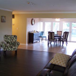 An open-plan living room with a dining area, featuring comfortable seating and abundant natural light.