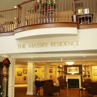 The entrance to The Massey Residence features a welcoming lobby with elegant decor and comfortable seating.