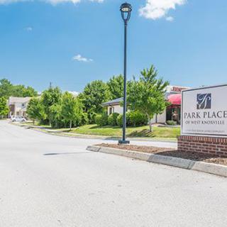 Entrance to Park Place Apartments with signage and surrounding greenery.