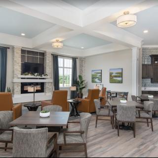 A modern living room interior with a cozy seating area, fireplace, and stylish decor.
