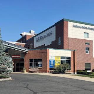 A view of a modern hospital building showing the entrance and surrounding area.