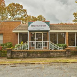 Front view of a business building with signage and a glass entrance.