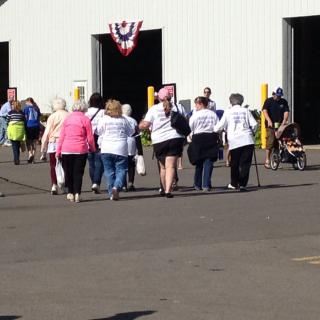 A group of people walking towards a building during an outdoor event.