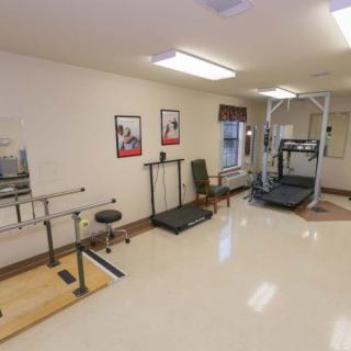 A well-equipped physical therapy room featuring various rehabilitation machines and equipment.