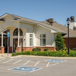 A building with a well-maintained facade and dedicated handicap parking spaces in front.