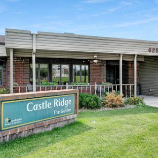 Entrance of Castle Ridge facility with a well-maintained lawn.