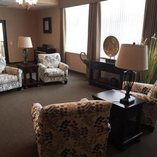 A cozy living room with patterned armchairs and soft lighting.