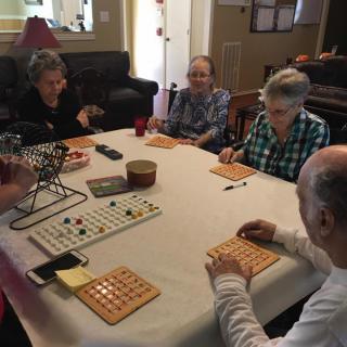 A group of seniors enjoying a game of bingo indoors.