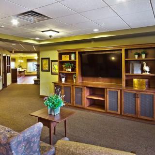 A cozy living room with a large entertainment center and comfortable seating.