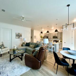 A modern open-plan living space featuring a cozy seating area, stylish kitchen with island, and an elegant dining area.