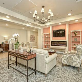 A cozy living room featuring elegant furniture and a warm fireplace.