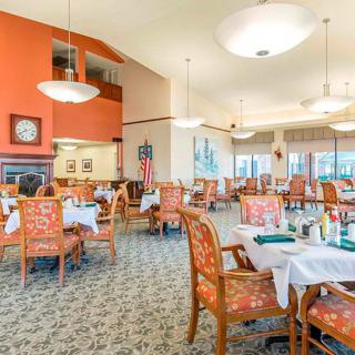 Spacious and elegantly decorated dining area with neatly arranged tables and chairs.