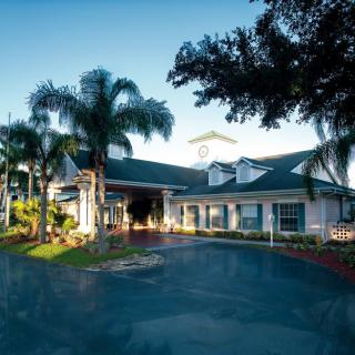 A welcoming entrance to a tropical hotel surrounded by palm trees.